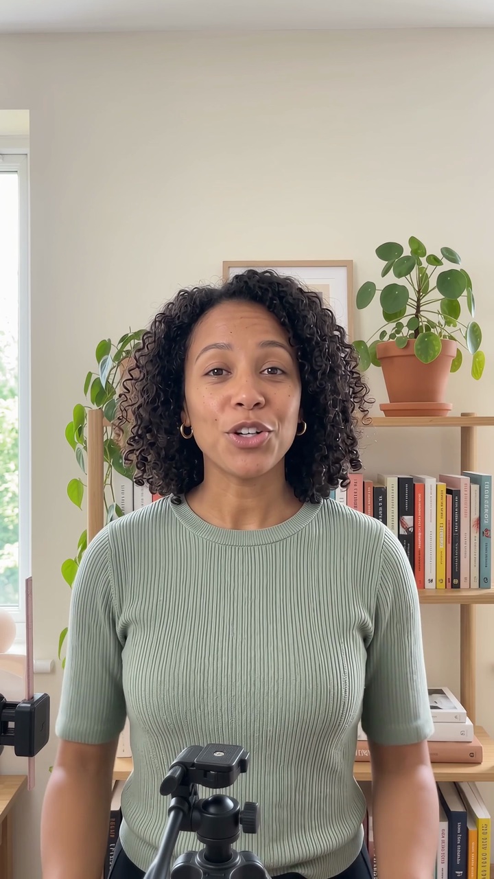 A frame from a raw phone video of an AI-generated presenter talking to camera in a living room, before any editing